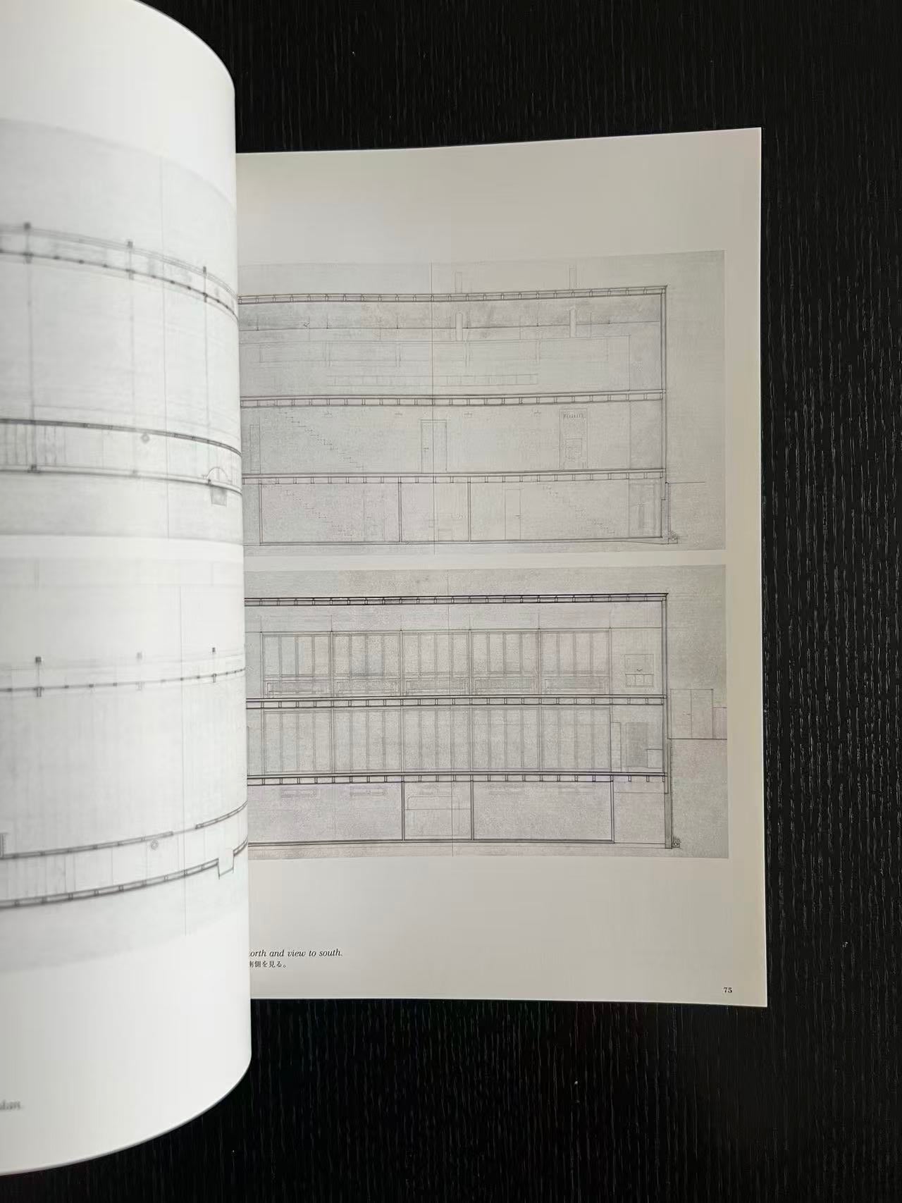Roll of graph paper with a sheet of architectural drawings on a black background