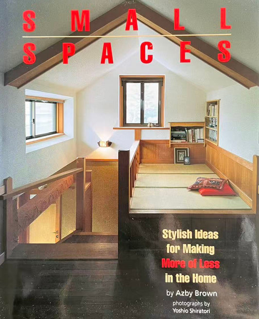 Book titled 'Small Spaces' on a dark wooden surface