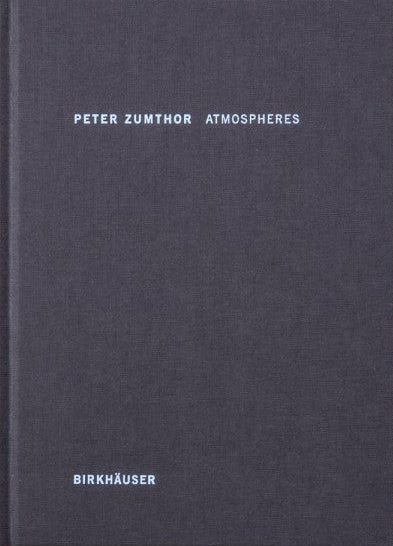 Dark blue book titled 'Peter Zumthor Atmospheres' by Birkhaéuser on a textured white background